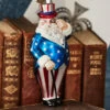 Raz Eric Cortina 5.5" Patriotic Santa Glass Christmas Ornament 4353129 -The Jolly Christmas Store 4353129 27797.1710437985